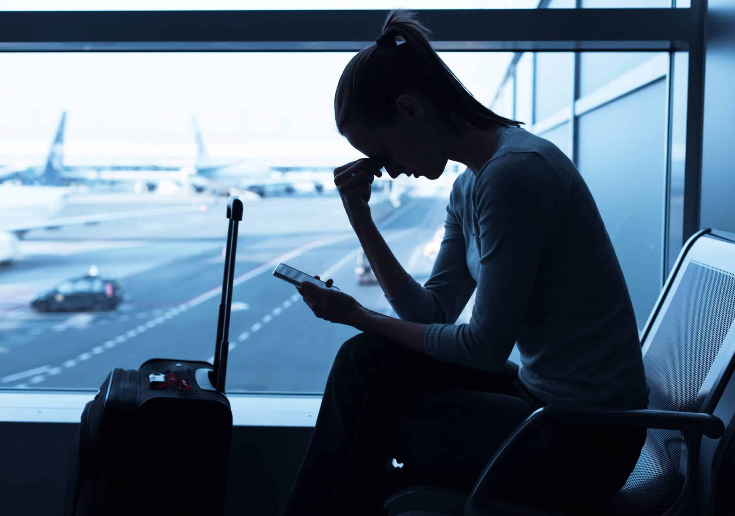 Woman experiencing booking issues on mobile device