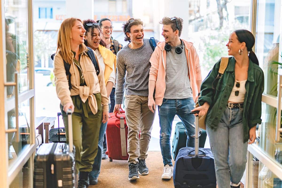 Happy travelers utilize and redeem travel loyalty program points to build community.&nbsp;
