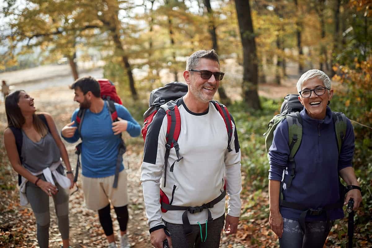 Outdoor enthusiasts enjoying a fall hike in their loyalty program rewarded camping gear and apparel.